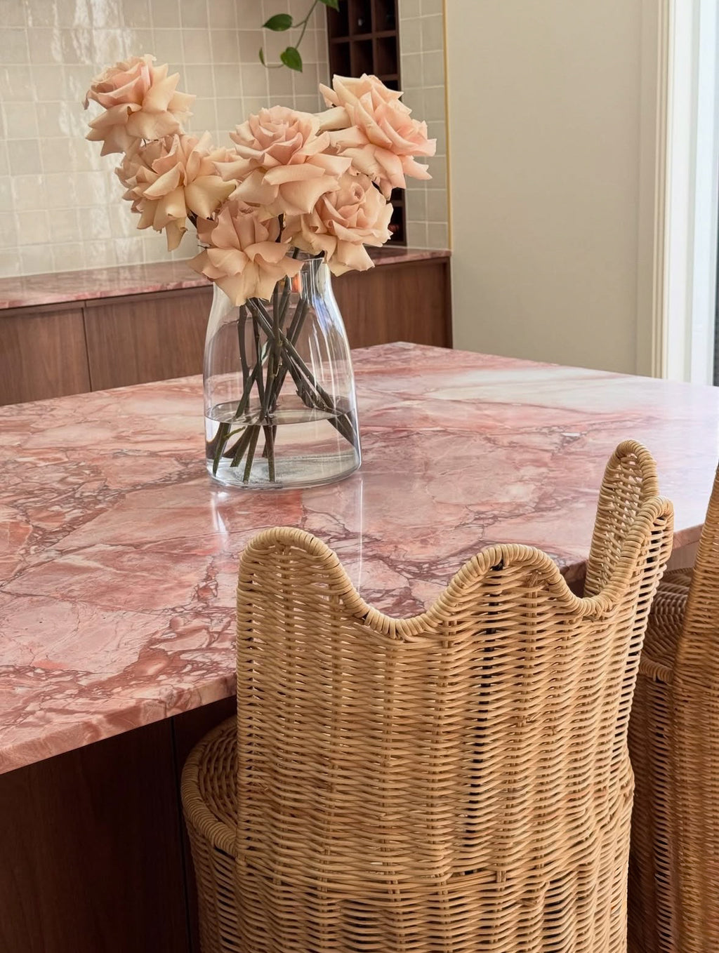 Custom handcrafted natural rattan bar stool with a sculptural curved backrest, designed for luxury kitchen islands and contemporary interiors.