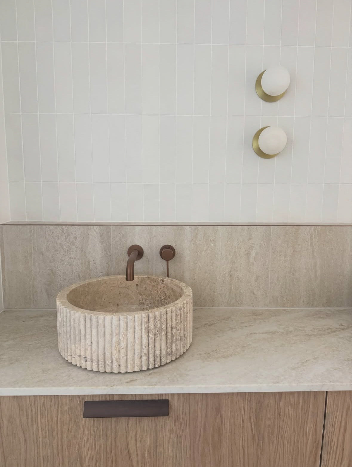Fluted marble basin handcrafted from natural stone featuring a sculptural fluted exterior and round above-counter design by HC Homewares.