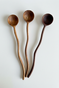 Three wooden spoons with wavy, organic-shaped handles, designed in HC Homewares luxury kitchen collection.