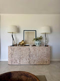 Handcrafted natural marble sideboard with rippled doors, curved ends and warm neutral stone, designed for luxury contemporary interiors.