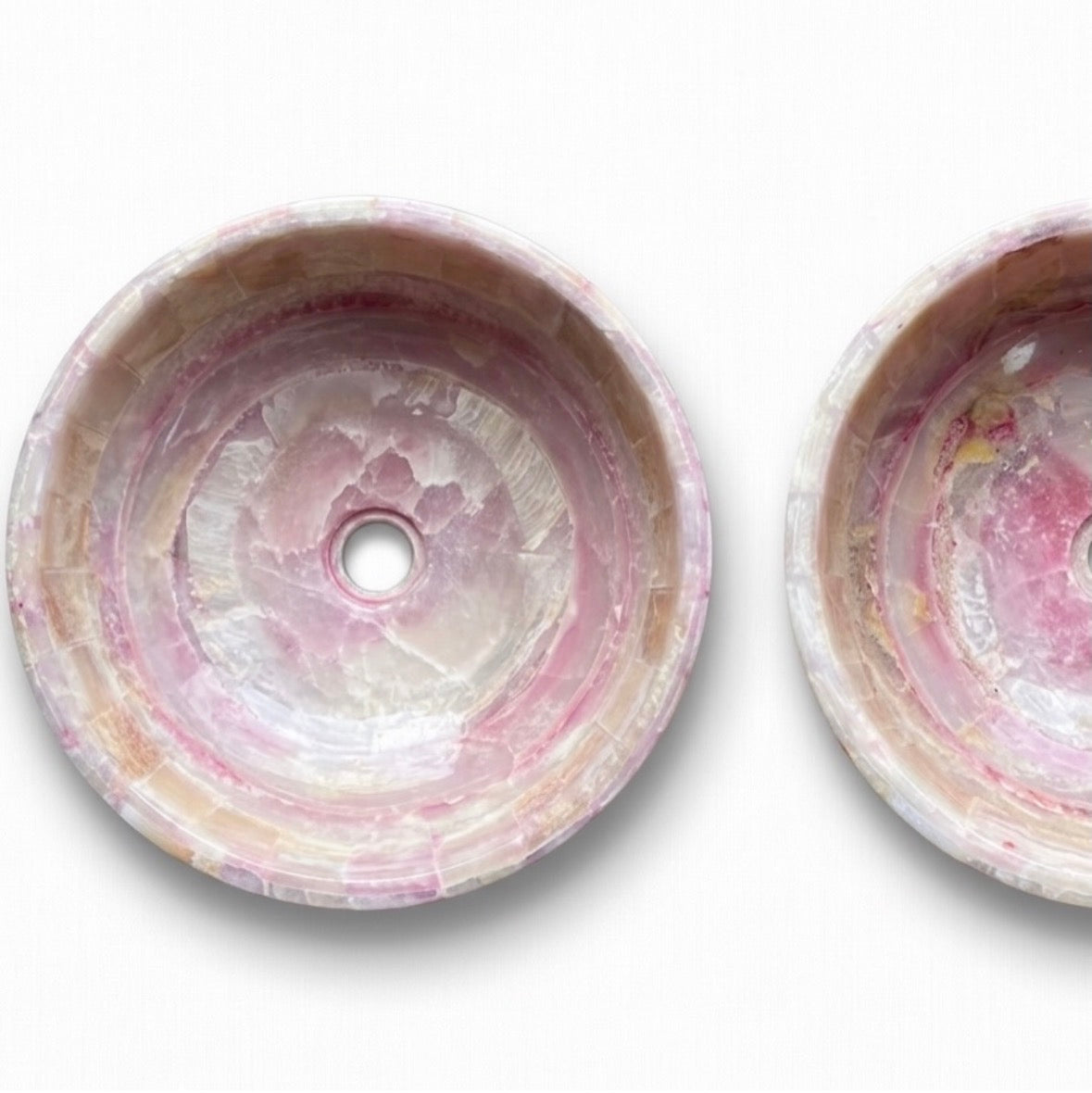 Two round onyx stone basins with a pink and white marbled pattern, designed by HC Homewares